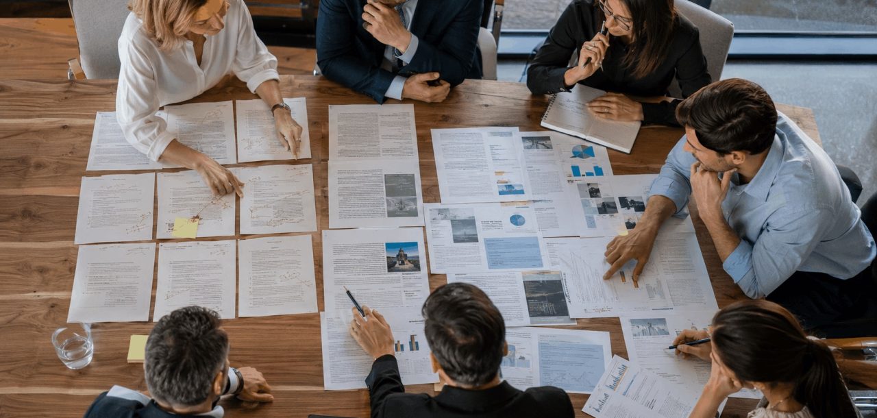 Marketing team evaluating expertise-driven blog content against generic AI-generated content during a content strategy workshop.